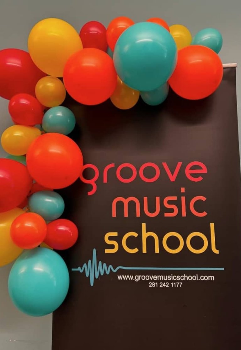 Groove Music School sign decorated with colorful balloon garland